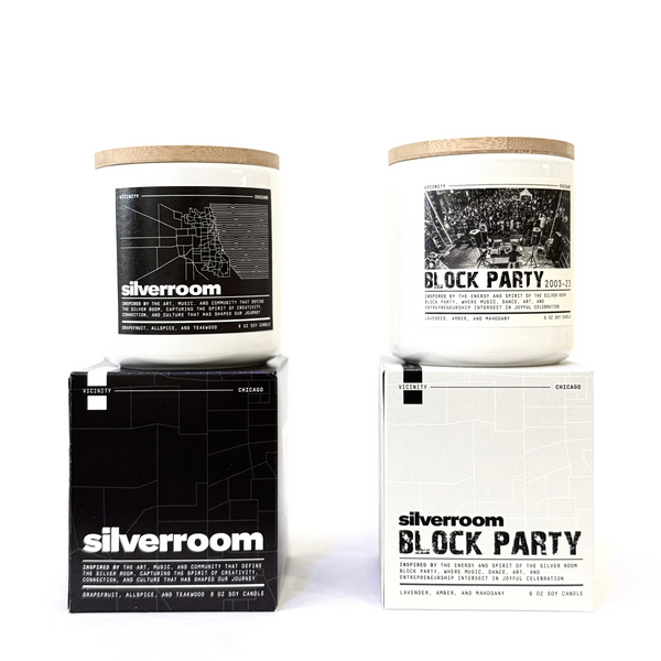 Two candles with labels 'Silverroom' and 'Block Party' on a white background